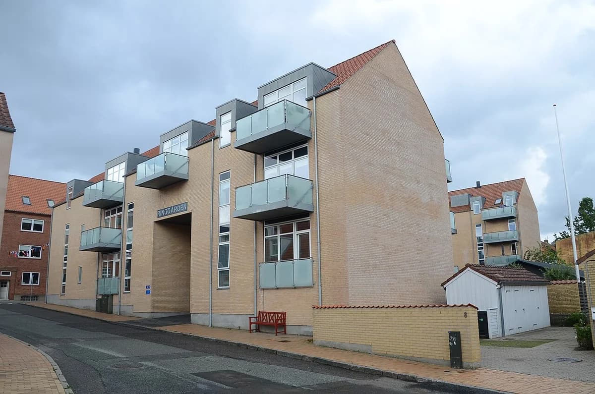 Apartment building with balconies on a street in Gråsten.