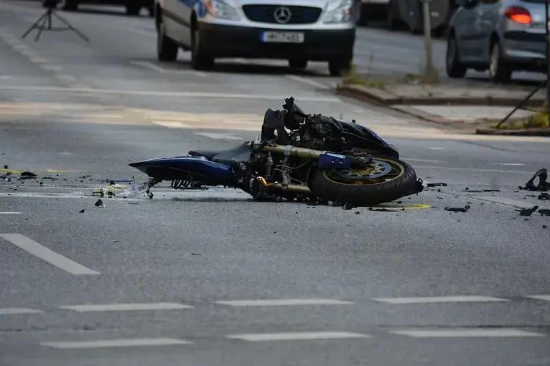 Damaged motorcycle lying on the road after accident